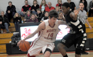 Raider Bennett Holley sidesteps an Evangel defender to drive to the paint Wednesday night.