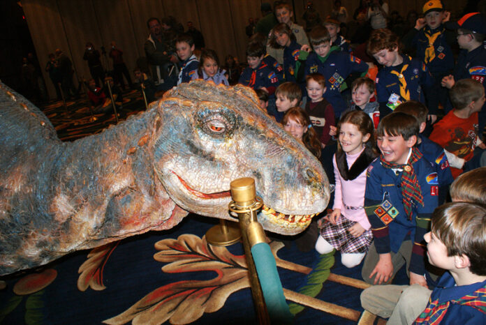Scouts and company meet baby T-Rex on Monday at the Hotel Roanoke.